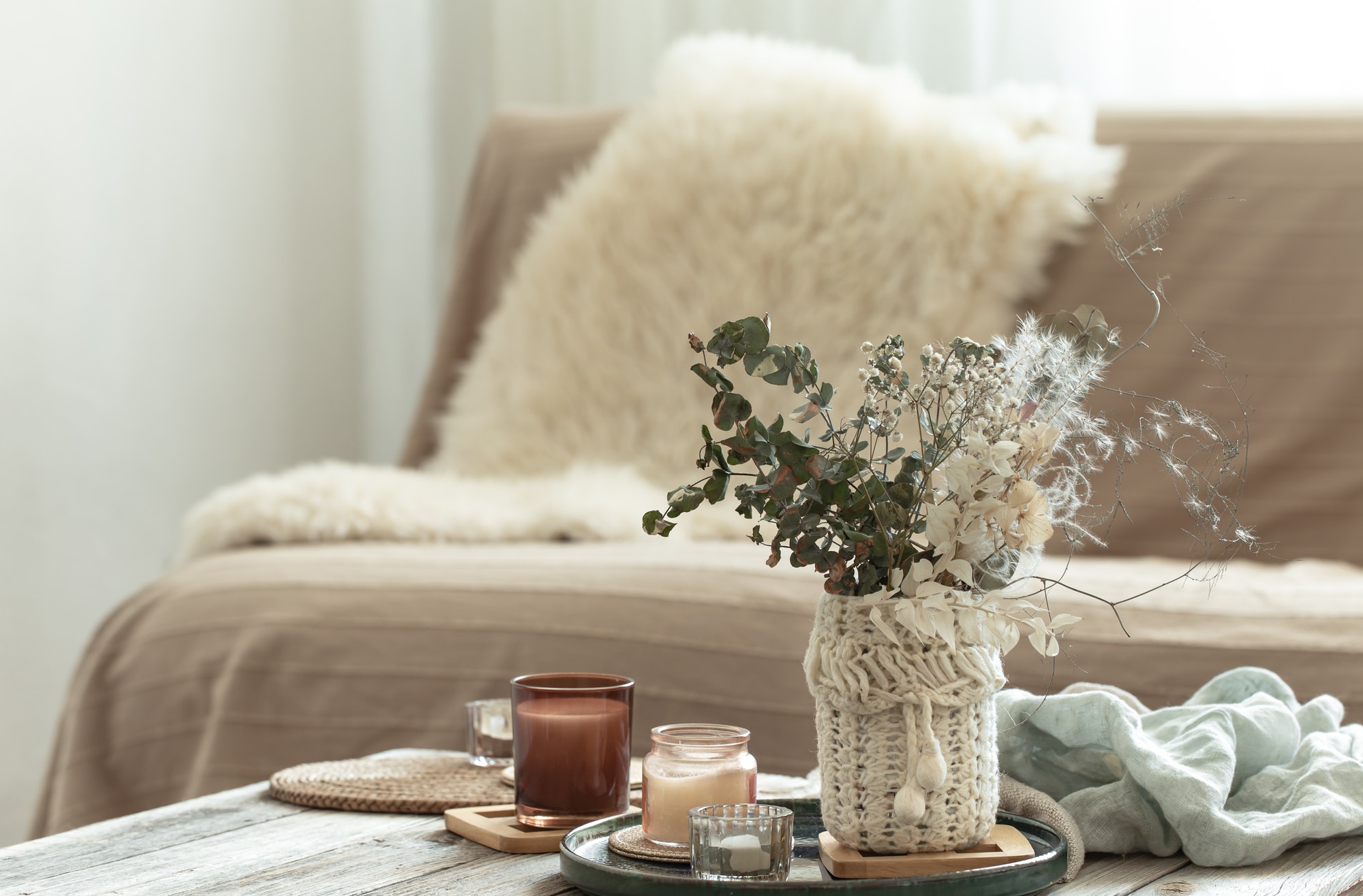 Cozy home background with dried flowers in a vase in the interior.
